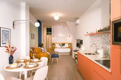 a kitchen and living room with a table and a couch at Park Central loft. Ruzzafa. in Valencia