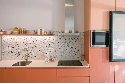 a small kitchen with orange cabinets and a sink at Park Central loft. Ruzzafa. in Valencia