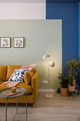 a living room with a yellow couch and a table at Park Central loft. Ruzzafa. in Valencia