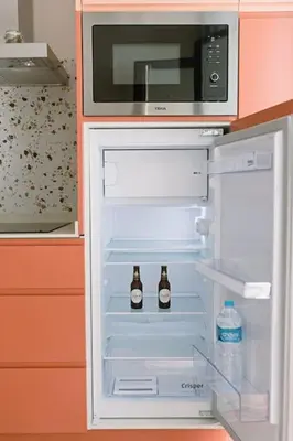an open refrigerator with two bottles of beer in it at Park Central loft. Ruzzafa. in Valencia