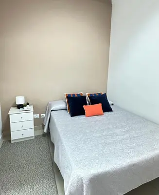 a bedroom with a bed and a night stand at The Valencia Stop in Valencia