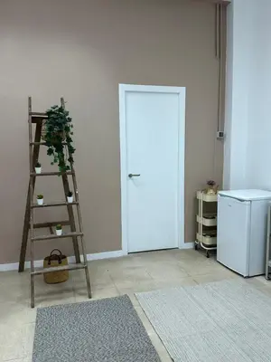 a room with a ladder and a refrigerator and a door at The Valencia Stop in Valencia