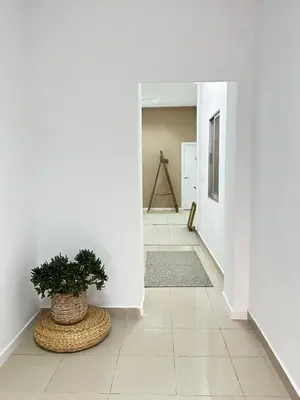 a hallway with a potted plant on the floor at The Valencia Stop in Valencia