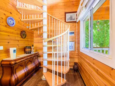 a spiral staircase in a log cabin with a window at Holiday Home La Alqueria de Jordi by Interhome in El Grao
