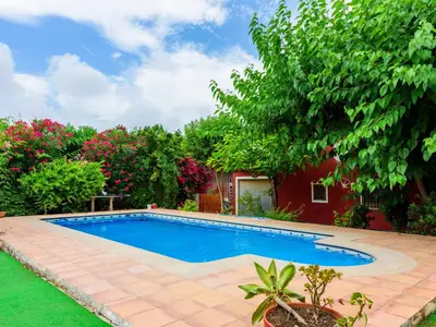 a swimming pool in a yard with trees and flowers at Holiday Home La Alqueria de Jordi by Interhome in El Grao