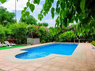 a swimming pool with blue water in a yard at Holiday Home La Alqueria de Jordi by Interhome in El Grao