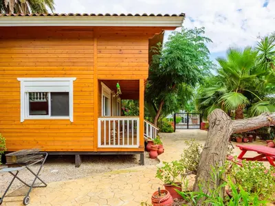 a small yellow house with a porch and a patio at Holiday Home La Alqueria de Jordi by Interhome in El Grao