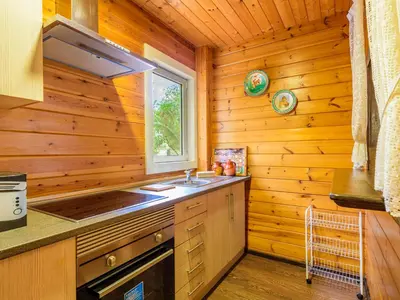 a kitchen with a sink and a window in a log cabin at Holiday Home La Alqueria de Jordi by Interhome in El Grao