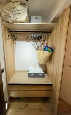 a closet with wooden shelves and a basket at Luxury apartment Y after renovation in Cullera with parking in Cullera