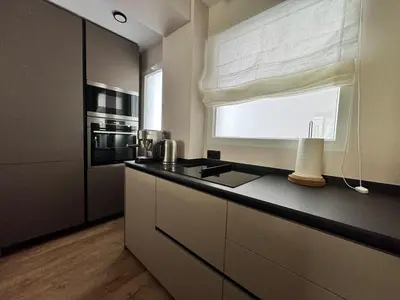a kitchen with a counter with a sink and a window at Luxury apartment Y after renovation in Cullera with parking in Cullera