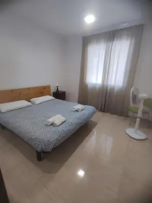 a bedroom with a bed with two towels on it at Planta baja, bien comunicada, cerca de la playa. in Valencia