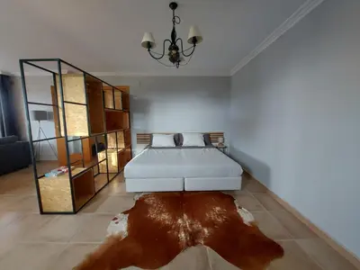 a bedroom with a bed and a large rug at Posada la Toscana in Montroy