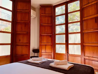 a bedroom with a bed with two towels on it at BET Apartments - Central Market Apartments in Valencia