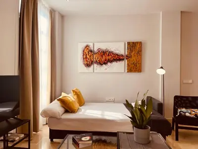 a living room with a couch and a painting on the wall at BET Apartments - Central Market Apartments in Valencia