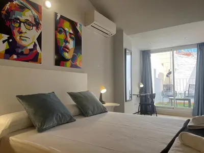 a bedroom with a bed with a painting on the wall at BET Apartments - Central Market Apartments in Valencia