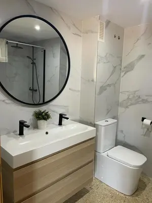 a bathroom with a sink and a toilet and a mirror at UIM Mediterraneo Emilio Llopis Wifi in Sagunto