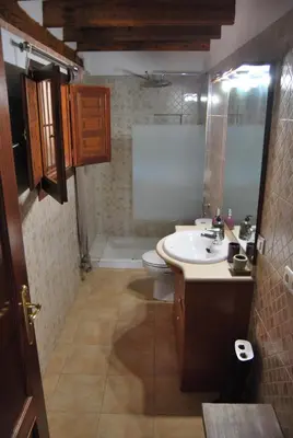 a bathroom with a sink and a toilet at CortijoRamon in El Brosquil