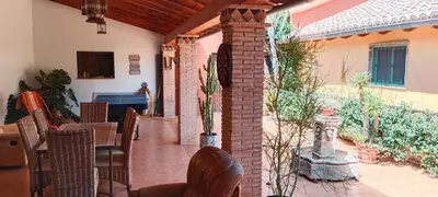 a patio with chairs and a table and a building at CortijoRamon in El Brosquil