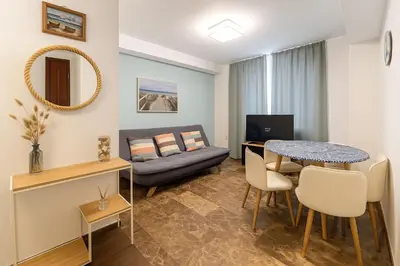 a living room with a table and a couch at Del Mar one bed flat in Puerto de Sagunto