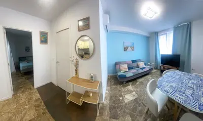 a living room with a couch a table and a mirror at Del Mar one bed flat in Puerto de Sagunto