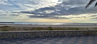 a view of the beach with a cloudy sky at cultura y playa in Puerto de Sagunto