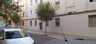 a white car parked on a street next to a building at cultura y playa in Puerto de Sagunto