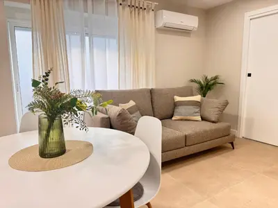 a living room with a white table and a couch at cultura y playa in Puerto de Sagunto