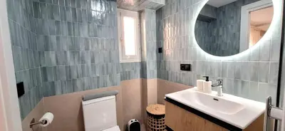 a bathroom with a sink and a toilet and a mirror at cultura y playa in Puerto de Sagunto