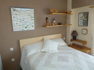 a bedroom with a bed with a white comforter at Espectacular terraza y vistas en 1a línea de playa in Cullera
