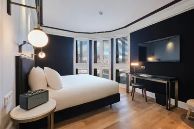 a bedroom with a bed and a desk and a television at ESTIMAR Valencia in Valencia