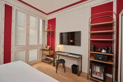 a bedroom with a bed and a desk and a tv at ESTIMAR Valencia in Valencia