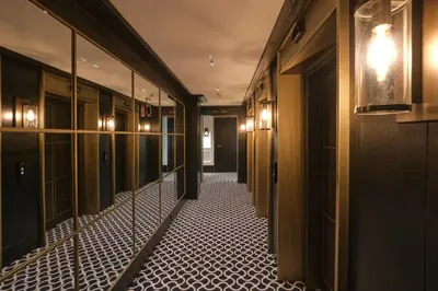 a hallway with a mirror and tile floor in a building at ESTIMAR Valencia in Valencia