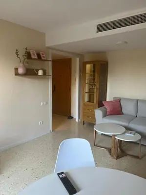 a living room with a couch and a table at Modern apartment in Valencia, Port Saplaya, by the sea in Port Saplaya