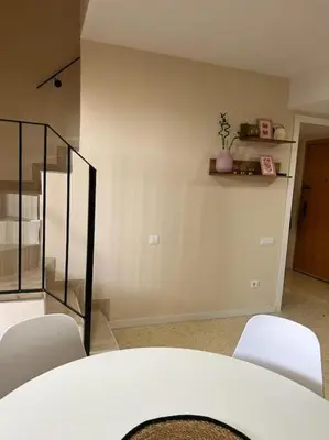 a dining room with white chairs and a table at Modern apartment in Valencia, Port Saplaya, by the sea in Port Saplaya