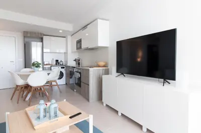 a living room with a large flat screen tv at Global Vacacional, Bonito apartamento con terraza en Gran Canet in Canet de Berenguer