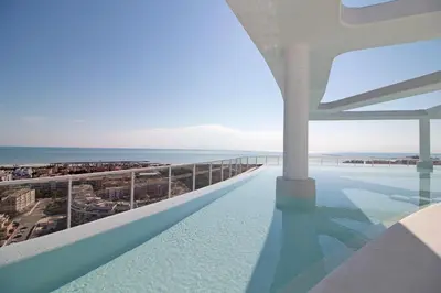 a swimming pool with a view of the ocean at Global Vacacional, Bonito apartamento con terraza en Gran Canet in Canet de Berenguer