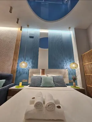 a bedroom with a large bed with towels on it at Lounge garden sea relax in Valencia