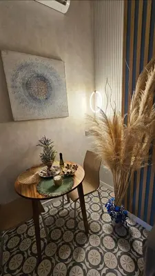 a living room with a table and a plant at Lounge garden sea relax in Valencia
