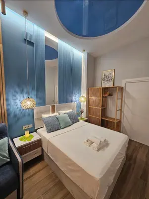 a bedroom with a large bed with a blue ceiling at Lounge garden sea relax in Valencia