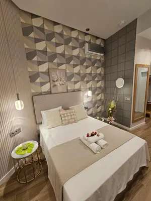 a bedroom with a large bed with towels on it at Lounge garden sea relax in Valencia