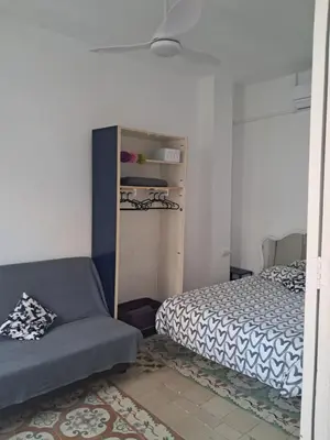 a bedroom with a bed and a chair in it at Apartamento muy céntrico en Valencia junto a Ruzafa in Valencia