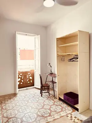 a room with a table and a chair and a window at Apartamento muy céntrico en Valencia junto a Ruzafa in Valencia