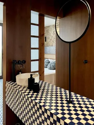 a bathroom with a black and white checkered table with a sink at El Rincón de María Vicenta in Valencia