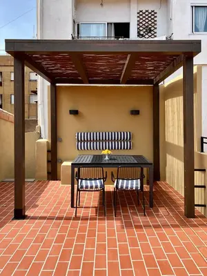 a patio with a table and chairs on a roof at El Rincón de María Vicenta in Valencia