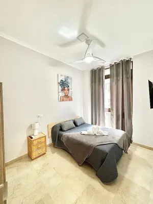 a bedroom with a bed and a window at Apartamentos Bobal Requena in Requena