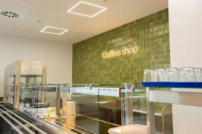 a coffee shop with a coffee shop sign on a wall at Micampus Burjassot Parque Student Residence in Burjasot