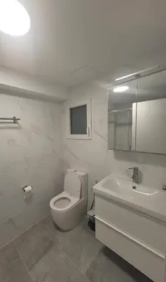 a white bathroom with a toilet and a sink at New and Bright 2-bedroom apartment in Cañamelar in Valencia
