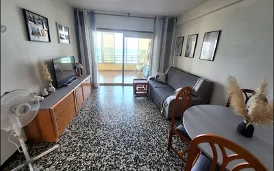 a living room with a couch and a tv at Tavernes de Valldigna Chez Svetlana in El Brosquil