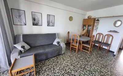 a living room with a couch and a table and chairs at Tavernes de Valldigna Chez Svetlana in El Brosquil