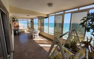 a room with a balcony with a view of the ocean at Tavernes de Valldigna Chez Svetlana in El Brosquil
